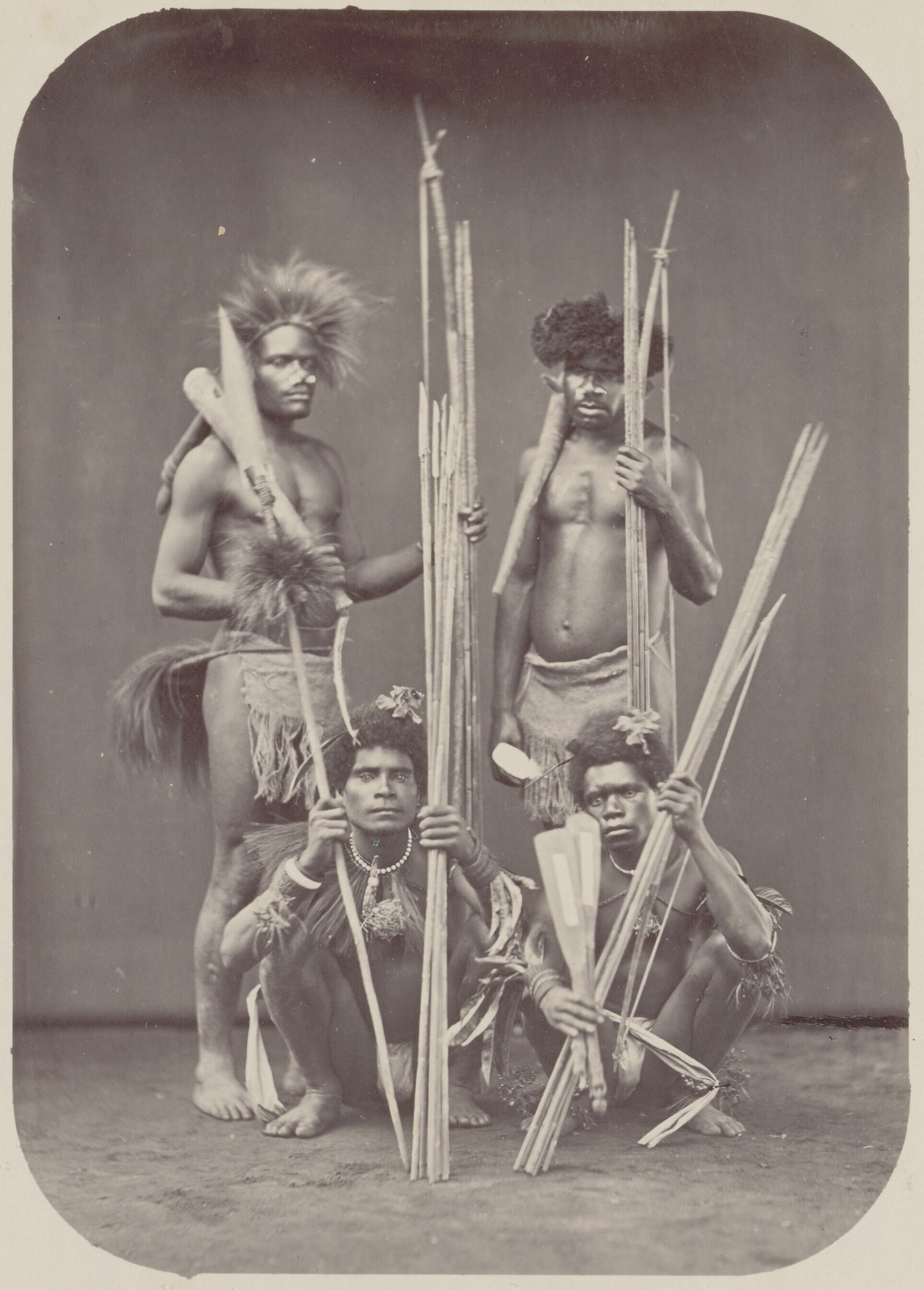 Studio portrait of a group 'Papuan men from Netherlands New Guinea dressed as warriors'